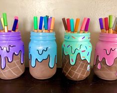 three jars with ice cream and colored pencils in them