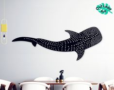 a large whale wall decal sitting on top of a dining room table