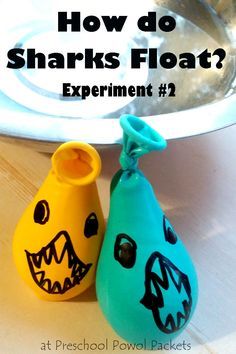 two plastic shark shaped vases sitting on top of a table