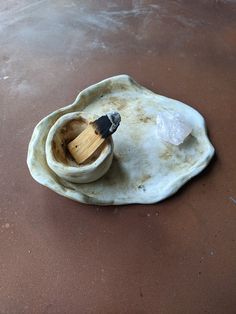 a wooden spatula sitting on top of an empty shell