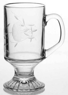 a glass cup with an apple etched on it