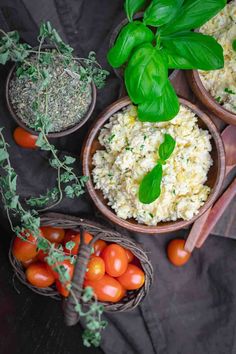 three wooden bowls filled with different types of food next to tomatoes, basil and garlic