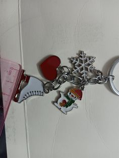 a close up of a key chain with snowflakes and other items on it