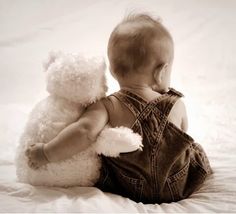 an angel holding a baby in his arms with stars above it and the sky behind him