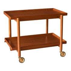 a wooden table with two shelves on wheels