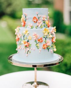 a three tiered cake decorated with colorful flowers