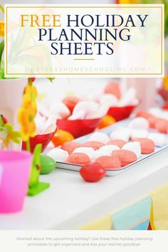 the free holiday planning sheets for homeschooling is displayed on a table with candy