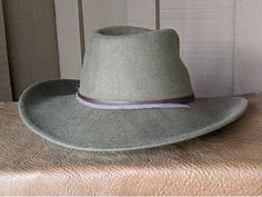 This 100% wool felt fedora is classically styled. Ready for your outdoor adventure! Perfect styling for a man or a woman. Simple leather hatband that is finished with a replicated Buffalo Nickel Concho. It has a stampede string to keep your hat on your head when the wind kicks up. Water resistant and crushable. The brim is 3.5" and the crown is 4.5" This hat ships within 2 - 3 days. Introduced in 1913, the Buffalo Nickel was an early hit with collectors and a major circulation workhorse through Vintage Felt Hat With Curved Brim For Outdoor, Adjustable Felt Hat With Flat Crown For Outdoor, Western Style Solid Color Hat Bands For Outdoor, Fitted Western Felt Hat For Outdoor, Western Style Fitted Felt Hat For Outdoor, Adjustable Wool Felt Hat For Country Events, Adjustable Wool Fedora For Country Events, Wool Fedora Adjustable For Country Events, Vintage Fitted Felt Hat For Outdoors