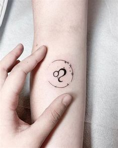 a person's arm with a small tattoo on the left side of their arm