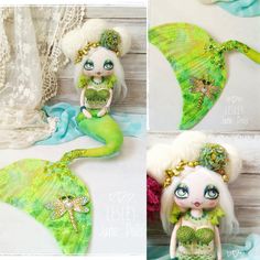 the doll is wearing a green mermaid outfit and holding a fish tail with her hands