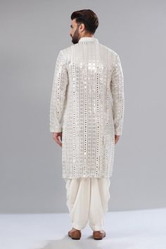 White kurta with silver mirror and sequin embroidery, a mandarin collar and long sleeves.
Components: 1
Pattern: Embroidered
Type Of Work: Sequin, Mirror
Neckline: Mandarin collar
Sleeve Type: Sleeveless
Fabric: Georgette
Color: White
Other Details: 
Attached cotton lining
Note: Pant worn by the model is not for sale.
Occasion: Mehendi and Puja, Sangeet - Aza Fashions Festive Silver Kurta For Festivals, Bollywood Style Silver Kurta For Diwali, Silver Kurta With Resham Embroidery For Festivals, Traditional Silver Kurta For Festivals, Silver Bollywood Kurta For Diwali, White Sherwani With Zari Work For Party, Festive Silver Kurta With Mirror Work, Silver Kurta With Mirror Work For Diwali, Festival Sherwani With Sequins And Straight Kurta