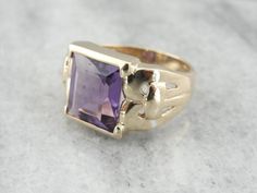 This stunning vintage ring features a luscious Amethyst center, square cut with a lot of glimmer! The simple mounting features beautiful filigree swirl cut-out shoulders that really make this unique and special! Metal: 10K Yellow Gold Gem: Amethyst 4.93 Carats Gem Measurements: 9.9 x 10.6 mm, Rectangle Ring Size: 7.75 Marks: "10K" Stamped on the inside band Formal Square Cut Amethyst Ring, Square Cut Amethyst Ring For Formal Occasions, Elegant Rectangular Amethyst Ring For Formal Occasions, Elegant Amethyst Ring With Rectangular Stone For Formal Occasion, Elegant Formal Amethyst Ring With Rectangular Stone, Classic Amethyst Ring With Rectangular Stone For Formal Occasions, Rectangular Amethyst Ring For Formal Occasions, Rectangular Amethyst Ring For Formal Events, Classic Purple Square Cut Ring