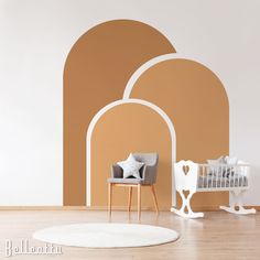 a baby's room with an arched wall and white furniture in the foreground