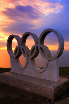 the olympic group project distance learning - middle school book cover image is an olympic symbol in front of a sunset