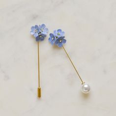 This beautiful porcelain Forget me not pin brooch is handmade and hand painted then embellished with Swarovski crystal detail.  Forget me not size: L2xW2xH1 cm.  Pin brooch is made of gold plated on brass.   Total length for the flower with pearl protector is 7.5 cm and 8cm for the plain protector.. This beautiful accessory will fit your favourite shirt, scarf, blazer or suit and best mood.  Add an original accent to your style and break up your routine.  Easy to wear and totally easy to impress! Great for everyday wear for both yourself and your loved one. Jewellery Care: Our jewellery is made from porcelain and should be treated as fragile. We recommend that customers should always remove your jewellery when applying scent, lotions and potions, or even better, always put your jewellery o Boutonniere Groomsmen, Brooch Scarf, Flower Luxury, Custom Lapel Pins, Scarf Buckle, Brooch Wedding, Angel Brooch, Dainty Rose, Wedding Brooch