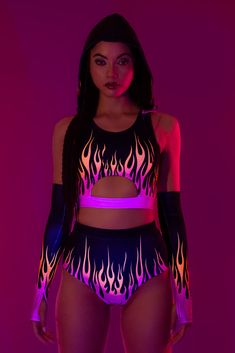 Flames flicker with your every move as the ultraviolet lights embrace you, leaving a trail of light in the darkness of night. The design features a sleeveless construction with a provocative cutout exposing the skin. A detachable hood provides an dash of mystery and and a lot of versatility. Take it off or put it on, just make sure to pair with the matching high waist shorts and gloves. FEATURES: > Detachable Oversized Hood  > Underbust Cutout  > Flattering Form-Fitting Construction  > Non–Transparent Lycra Fabric Romper Men, Wwe Outfits, Wrestling Gear, Rave Babe, Light In The Darkness, Festival Outfits Rave, Look Festival, Performance Outfits, Pole Wear