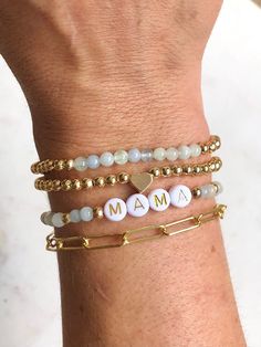 🔹 Design the personalized word bracelet that you have always wanted! These stacking mama bracelets can be personalized so you can get exactly what you want. 🔹Please add each bracelet style separately to your cart. They will be sent to you as a stack.  🔹They are made with 4mm amethyst, rose quartz, howlite, grey agate or aquamarine gemstones beads, 18k gold plated, 18k Gold Filled, Sterling Silver Plated or Rose Gold beads and then strung together with a strong double- strung elastic cord. The paperclip chain bracelet is 18k gold plated. Bead color may vary slightly. Gold filled beads have a much thicker gold coating and will last for years.  🔹Each stackable set makes the perfect gift for yourself or for Christmas, a baby shower, new mom, Mother's Day, bridal shower, birthday and Valent Christian Bracelet Stack, Customizable Meaningful Bracelets For Everyday, Handmade Mother's Day Charm Bracelet, Inspirational Personalized Letter Beads Jewelry, Handmade Meaningful Bracelets For Mother's Day, Meaningful Letter Beads Jewelry For Mother's Day, Meaningful Handmade Bracelets For Mother's Day, Customizable Inspirational Everyday Bracelets, Stackable Beaded Bracelets For Mother's Day Personalized Gift