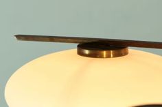 a close up of a light fixture on a table top with a blue wall in the background