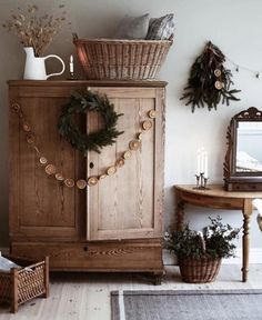 a wooden cabinet with wreaths and lights on it