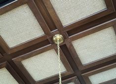 a ceiling with wooden paneling and lights hanging from it