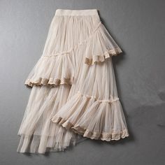 Beige Non-stretch Tiered Skirt, Summer Stretch Asymmetrical Maxi Skirt, Summer Stretch Beige Skirt, Spring Stretch Maxi Skirt With Asymmetrical Design, High Waist Summer Tulle Skirt, High Waist Tulle Skirt For Summer, Spring Stretch Asymmetrical Maxi Skirt, Non-stretch Ruffled Skirt, Summer Pleated Asymmetrical Skirt