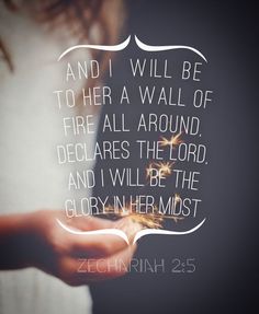 a person holding a lit candle in their hand with the words, and i will be to her a wall of fire all around