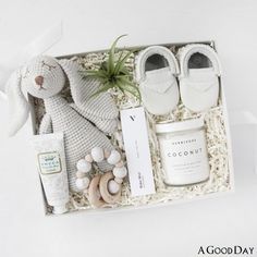 a white box with some items in it and a stuffed animal next to it on a table