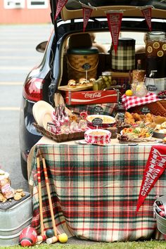 a trunk full of food sitting in the back of a car