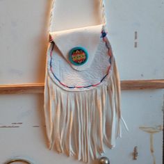 a small white purse hanging on the wall