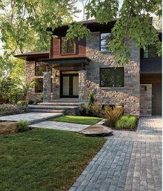 a house that is surrounded by grass and trees