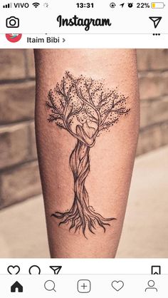 a tattoo on the leg of a woman with a tree and a heart in it