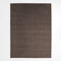 a brown rug on a white wall