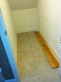 an empty room with wood flooring and white walls