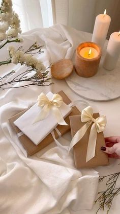 a table with candles and wrapped gifts on it