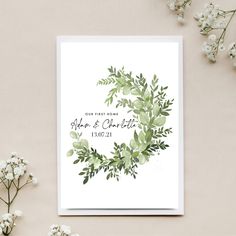 a wedding card with watercolor greenery on it and the words, our first home