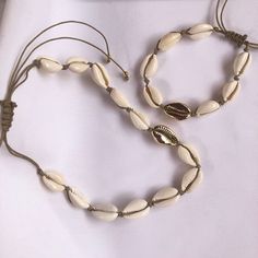 White and Gold cowrie shell choker, cowrie shell necklace, sea shell necklace, gold shell necklace, cuff choker necklace, shell jewelry Gorgeous white and gold cowrie shell choker with bracelet or anklet bracelet with sea inspiration. This cowrie shell necklace is perfect for several styles: boho, minimalist, modern, chic... The necklace, bracelet, and anklet bracelet are adjustable in length with a sliding knot, so that you can wear it short or long and the cord ends in four delicate endings wi Gold Shell Necklace, Sea Inspiration, Dangle Cross Earrings, Crescent Moon Necklace Gold, Sea Shell Necklace, Cowrie Shell Necklace, Necklace Shell, Moon Phases Necklace, Shell Choker