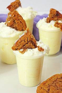 three dessert cups filled with whipped cream and cookies