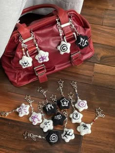 a handbag and several charms on a wooden floor