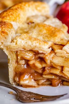 a piece of apple pie sitting on top of a white plate