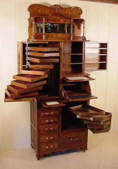 an antique wooden desk with drawers and mirror