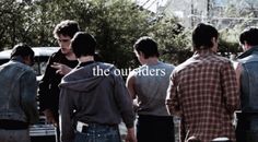 a group of young men standing next to each other in front of an old truck