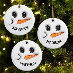 three personalized ornaments hanging from a christmas tree