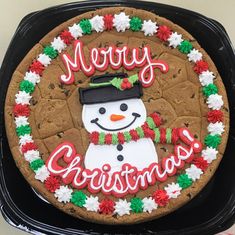 there is a decorated christmas cookie in the shape of a snowman on top of it