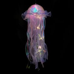 a light up jellyfish hanging in the dark