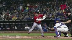 a baseball player swinging a bat on top of a field in front of a crowd