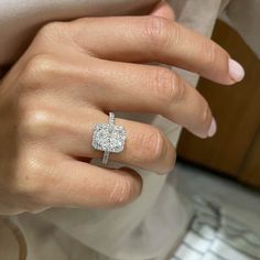 a woman's hand with a diamond ring on it