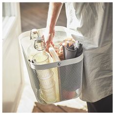 a person holding a basket full of food in it's left hand, with the lid open