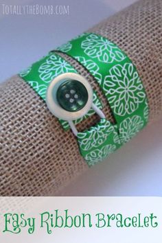 a green and white bracelet with a button on it