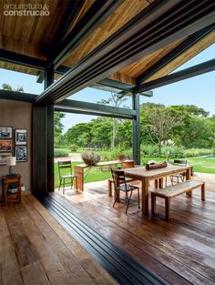 an image of a wooden deck with chairs and table in the foreground, on instagram