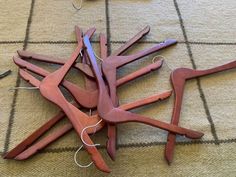 several pieces of wood are laying on the floor next to scissors and thread spools